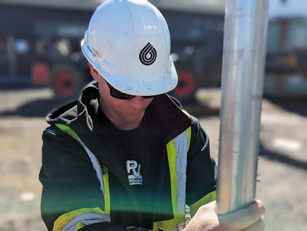 Well technician doing a commercial well pump installation in Ottawa.